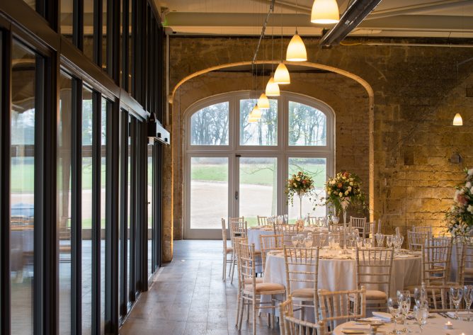 Cotswold stone arches of the original stone barn, looking through Northwick Barn