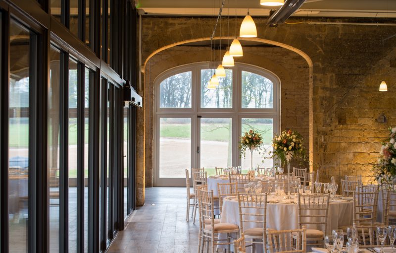 Cotswold stone arches of the original stone barn, looking through Northwick Barn