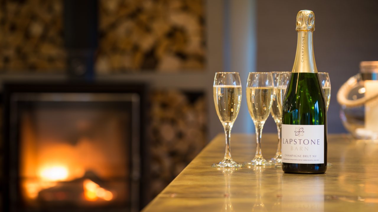 Glasses of champagne on the bar at Lapstone Barn