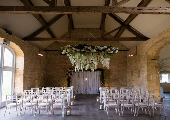 Stunning flower wheels suspended from the rafters of this beautiful Cotswold barn