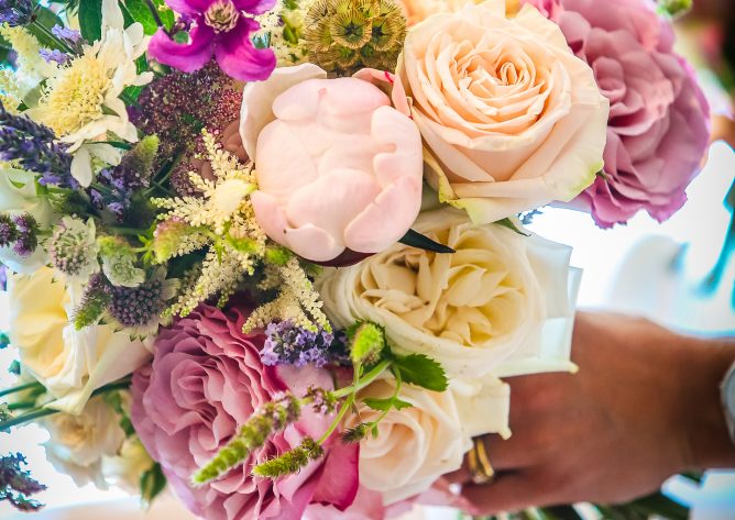 Bride holding a stunning hand tied flower bouquet