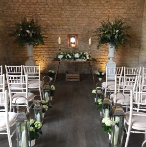 Dramatic floral arrangements at Lapstone Barn, which fill the light airy spaces typical of barn wedding venues