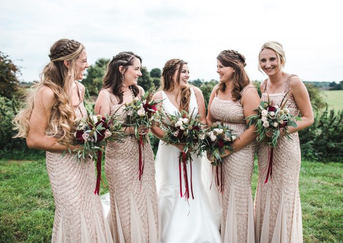 Bride and bridesmaids posing with their wedding bouquets