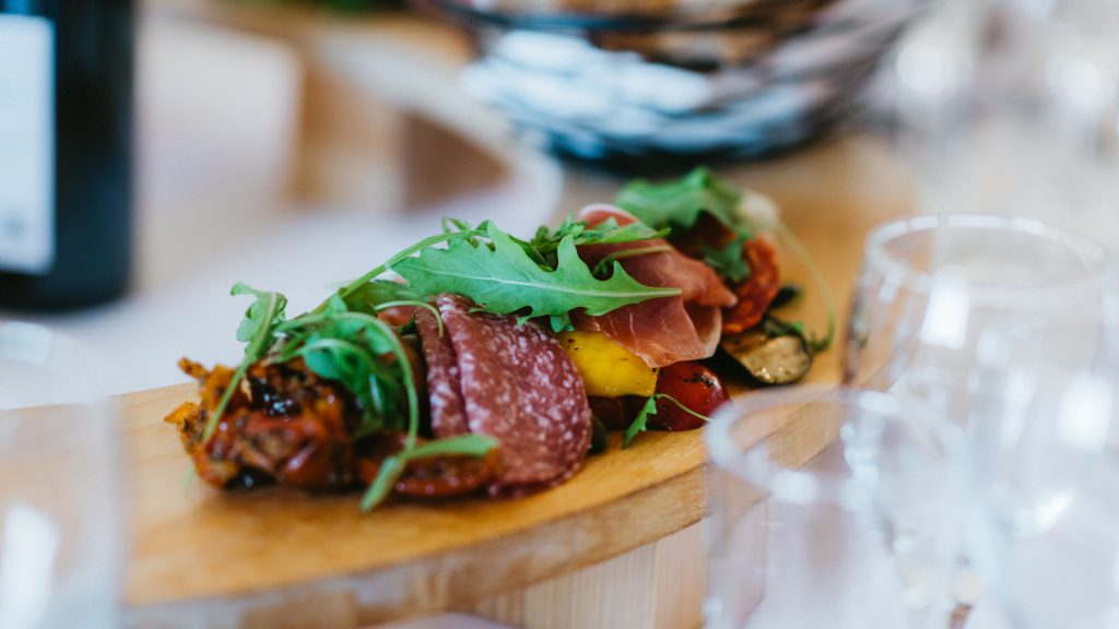 Antipasti starter presented on a circular maple board