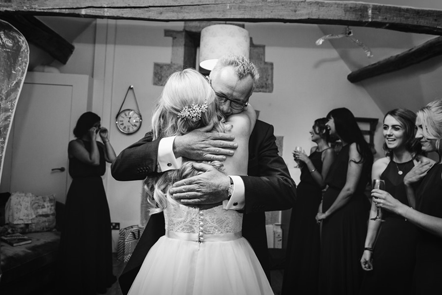 Bride and father of the bride embracing before the wedding ceremony