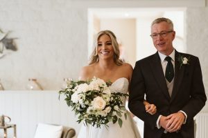 Father of the bride walking the bride in to the wedding ceremony