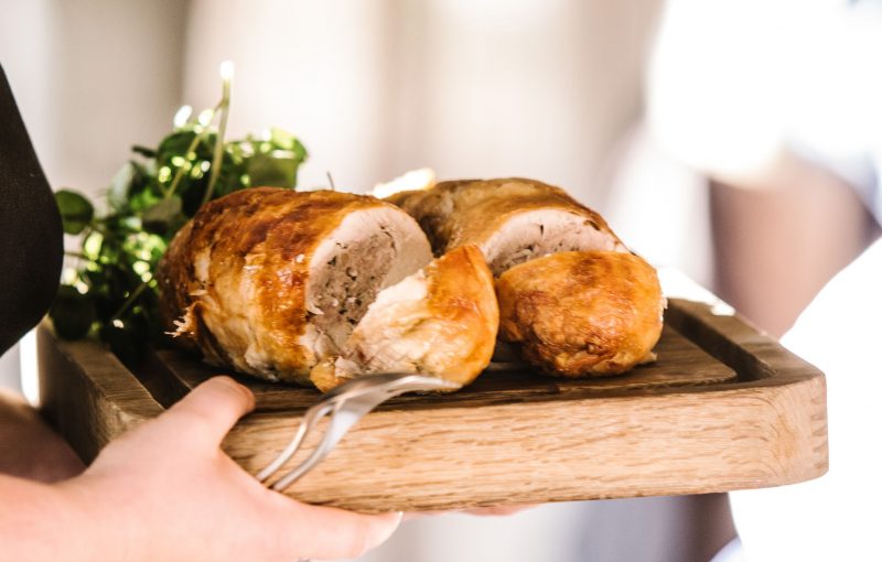 Loin of pork on a board, to be served at the wedding breakfast
