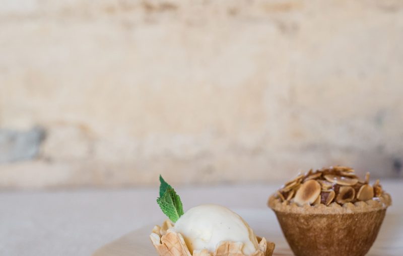 Cherry Bakewell Tart with Dairy Ice Cream served on a white plate