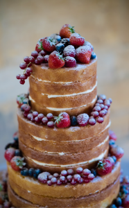 Naked wedding cake decorated with summer berries