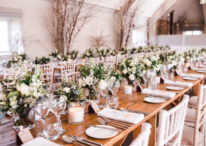 Rustic trestle tables set up for the wedding breakfast