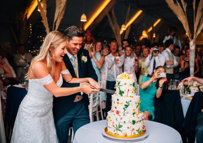 Bride and groom cutting their wedding cake
