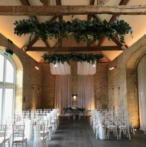 Drapes and foliage decorating the wedding ceremony space