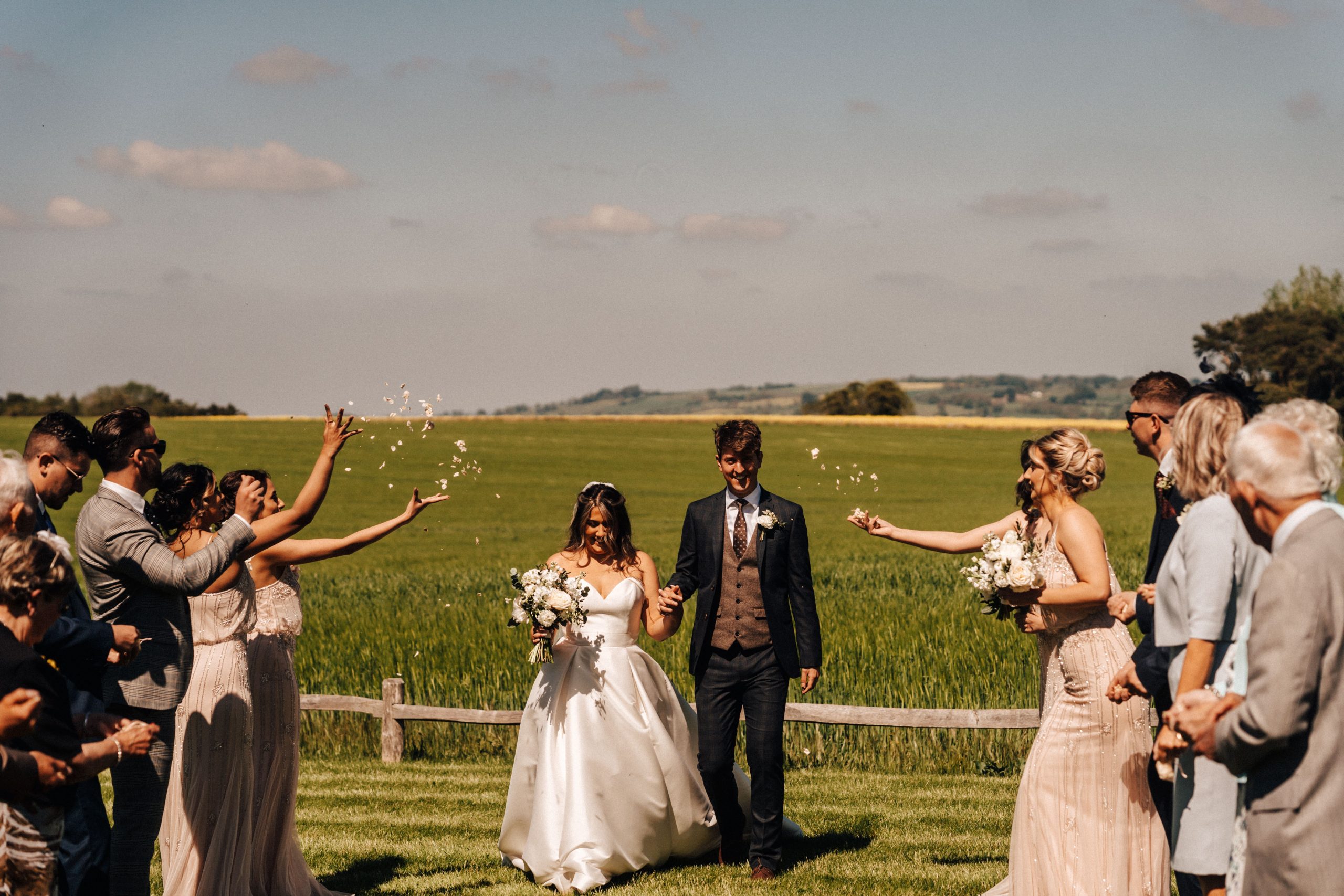Bride and groom walking through confetti