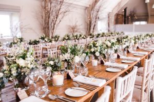 Floral arrangements and place settings at the wedding breakfast