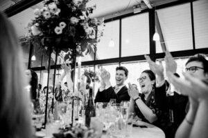 Wedding guests cheering at their tables